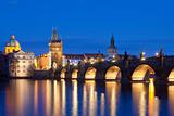 czech republic, prague - charles bridge and spires of the old town at dusk