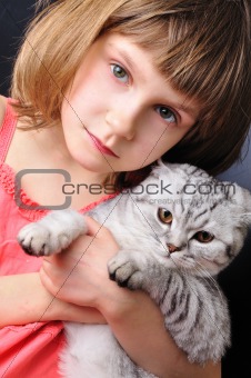 child with her pet cat