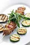 turkey skewer with bacon and grilled vegetables
