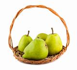 Green ripe pears in wicker basket