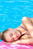 Beautiful woman lying close to pool