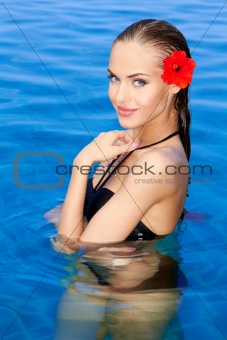 Tropical girl with flower on her ear