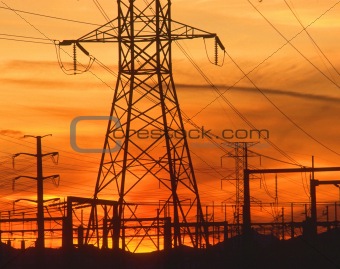 Electricity pylons at orange sunset 