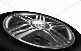 Background closeup on automotive wheel on an alloy metallic rim and hub with spokes lying on its side as though removed for a breakdown or puncture, isolated on white