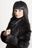 Portrait of a beautiful elegant woman in a black coat 