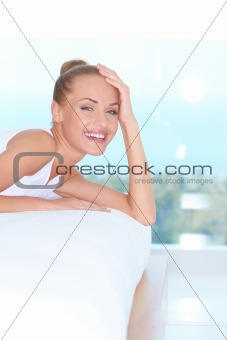 Laughing woman looking over back of sofa