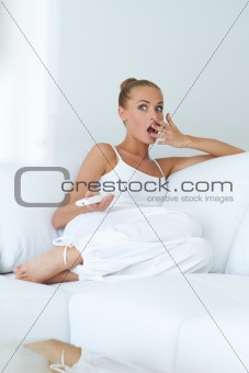 Young woman is in shock while watching tv