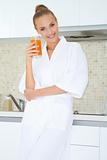 Woman enjoying fresh orange juice for breakfast