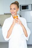 Stylish woman drinking healthy orange juice
