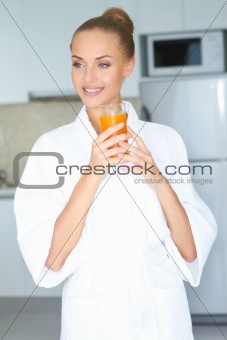 Stylish woman drinking healthy orange juice