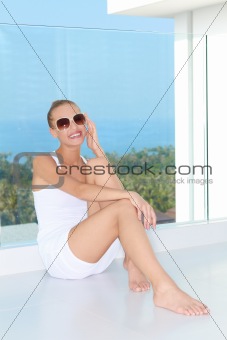Sensual woman sitting at balcony with a view