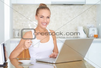 Laughing woman sitting at laptop computer