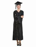 Full length portrait of woman in graduation cap and gown isolated
