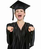 Graduation student woman pointing on you isolated