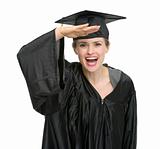 Graduation woman with hand near forehead looking into camera isolated