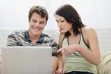 Girl showing to boyfriend something in laptop