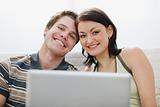 Portrait of young couple with laptop