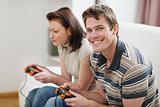 Young man playing on console with girlfriend