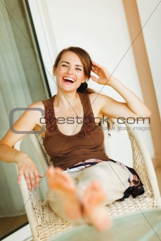 Laughing woman relaxing on terrace