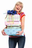 Happy elderly woman with stack of present boxes