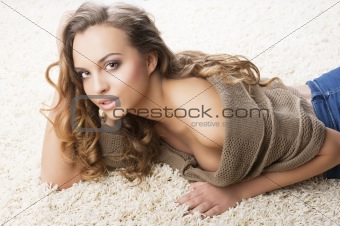 sweet young girl laying on carpet with sensal expression