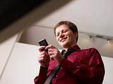 man typing sms on smartphone and smiling