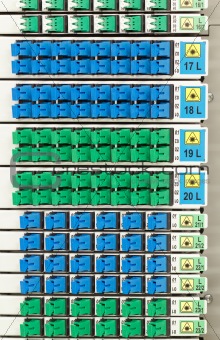fiber optic rack with high density of blue and green SC connectors