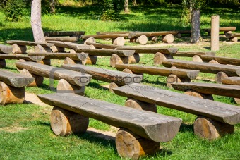 outdoor wood benches on green lawn
