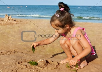 Little girl playing on the seaside