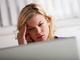 Headache and health problems for young woman at work