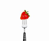 Strawberry pierced by fork,  isolated on white background 