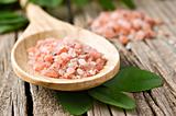 Course pink Himalayan salt on a wooden spoon