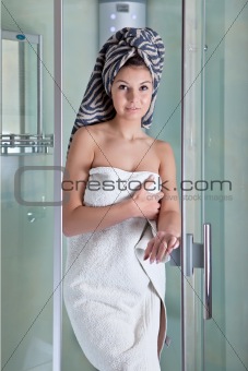 Beautiful girl after a shower in a white towel