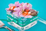 flowers in a glass dish with slices of fish