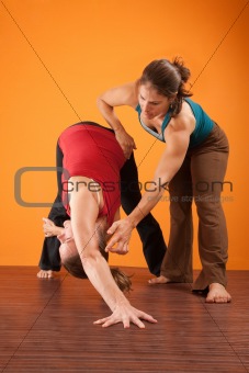 Yoga Instructor Helping Student