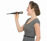 Woman singing in microphone isolated