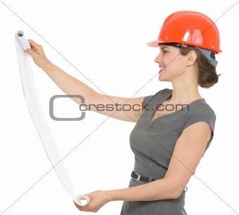 Happy architect woman looking on flipchart isolated