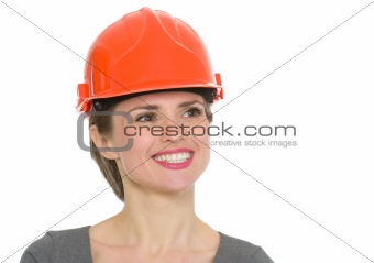 Portrait of dreaming architect woman in helmet isolated