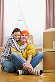 Portrait of moving young couple among boxes