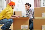 Moving young couple searching something in box