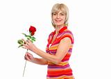 Happy elderly woman holding red rose