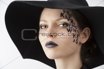 the letter on the face creative makeup girl, close-up portrait