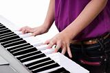 close up of young girl  playing keyboard