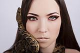beautiful brunette girl with a snake around her head
