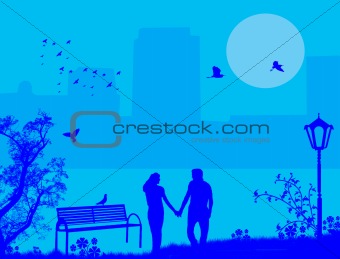 Couple in a city park on blue