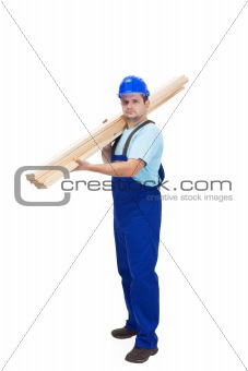Construction worker carrying wooden plancks