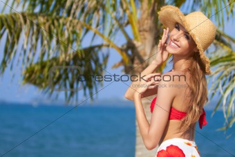 Joyful girl in red bikini posing at the beach