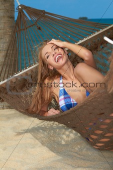 High-spirited laughing woman in hammock
