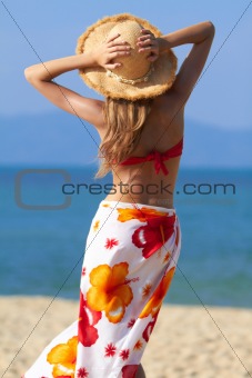 Woman in sarong and straw hat