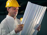Adult male engineer holding building blueprints